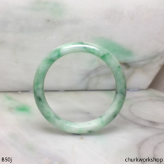 Small white base with splotches green jade bangle