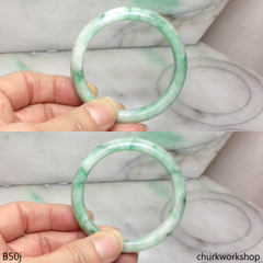 Small white base with splotches green jade bangle