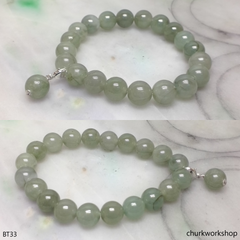 Light green beads jade bracelet with small charm