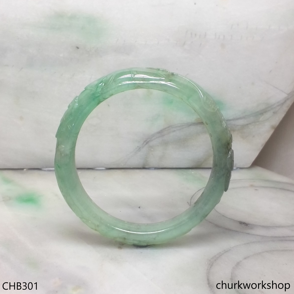 Carved light green jade bangle