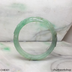 Carved light green jade bangle