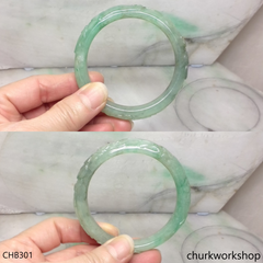 Carved light green jade bangle