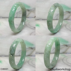 Carved light green jade bangle
