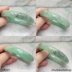 Carved light green jade bangle