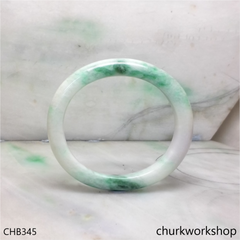 White base with green splotches oval jade bangle