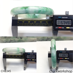 White base with green splotches oval jade bangle