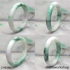 White base with green splotches oval jade bangle