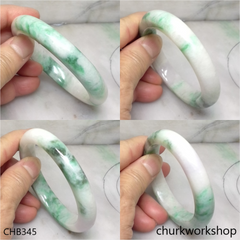 White base with green splotches oval jade bangle