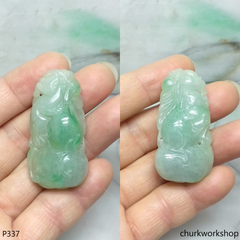 Light green carved jade pendant.