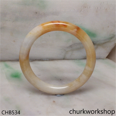 Light yellowish with splotches brown bangle