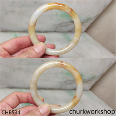 Light yellowish with splotches brown bangle