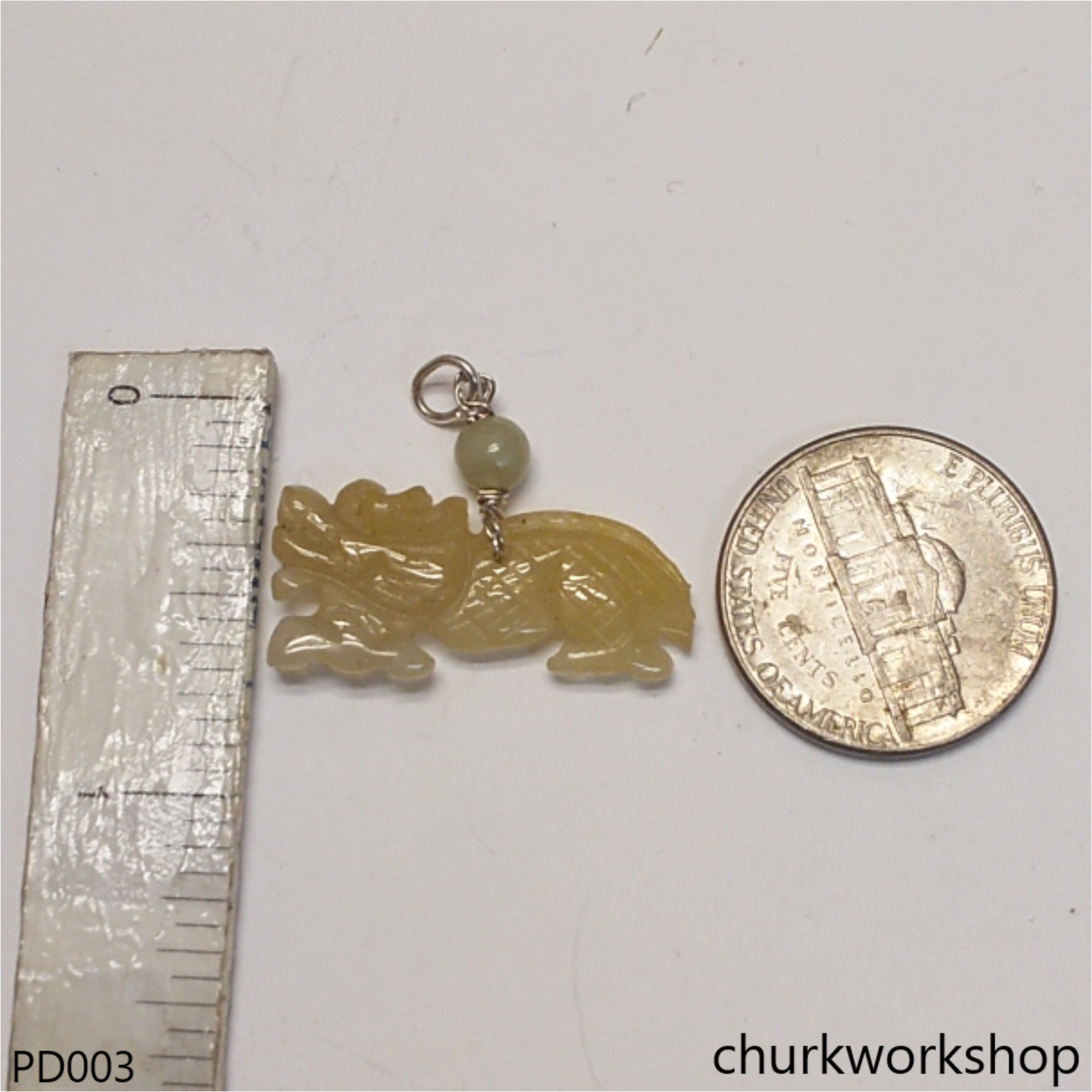 Light yellowish jade dragon pendant