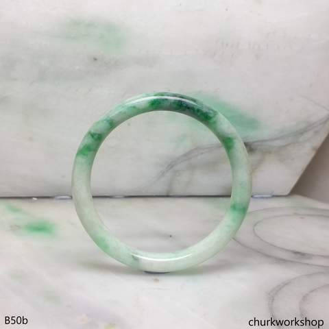 Small white base with splotches green jade bangle