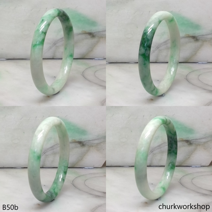 Small white base with splotches green jade bangle
