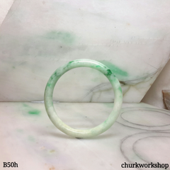 Small white base with splotches green jade bangle