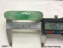 Small carved light green jade bangle