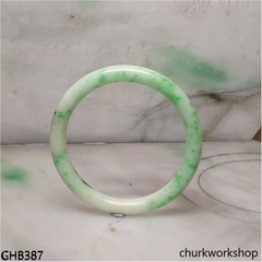 Very small white base with splotches green jade bangle