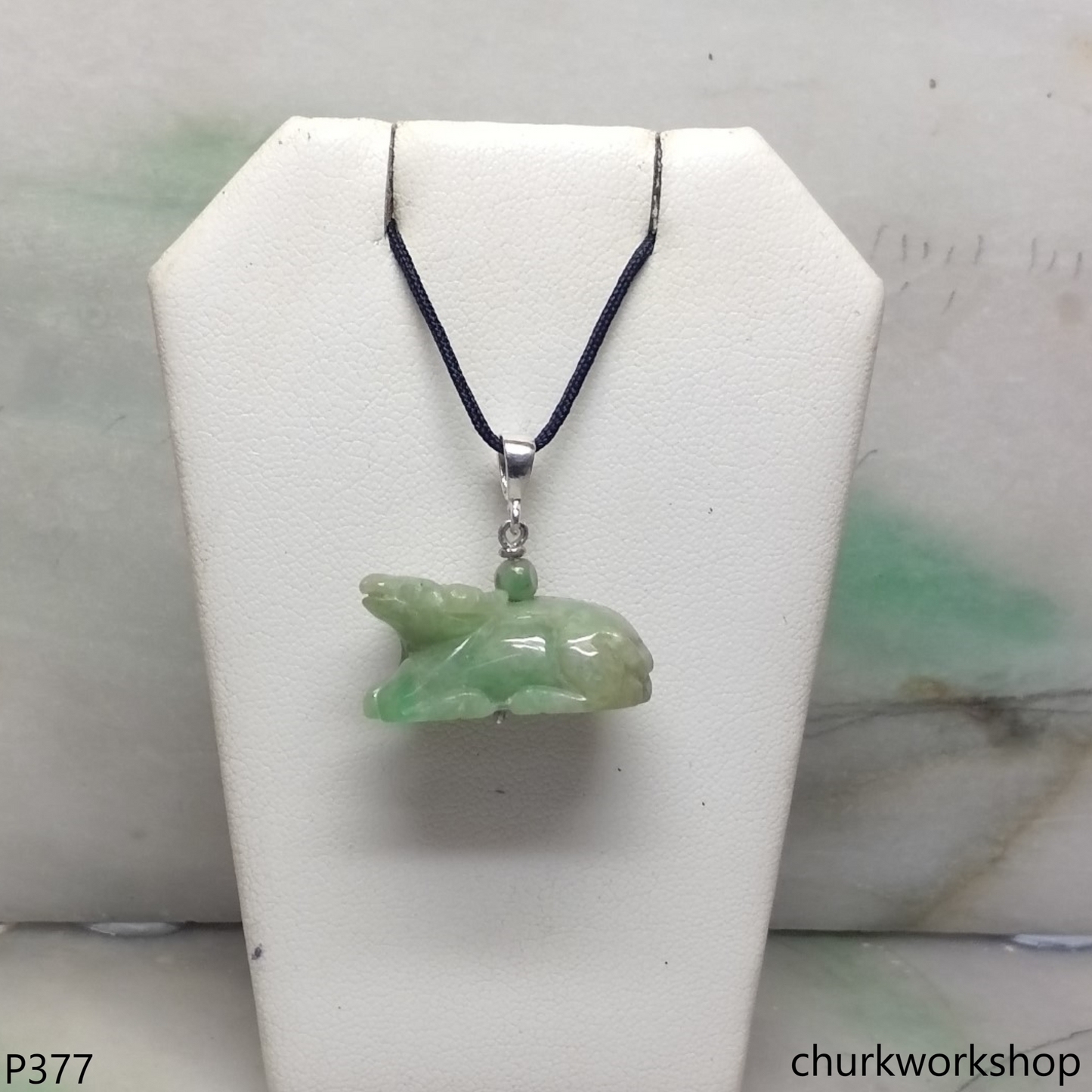 Green jade Ox pendant with silver bail