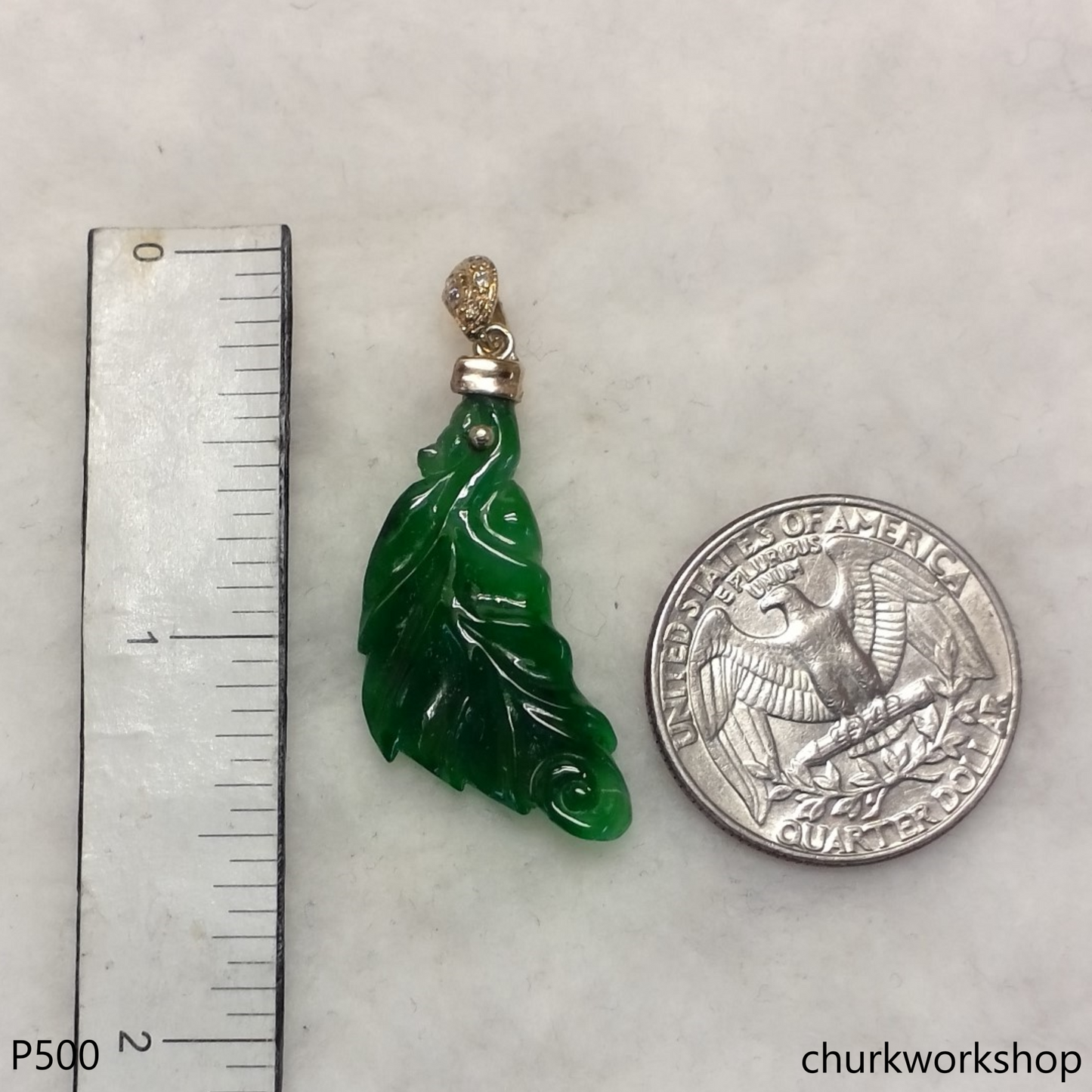 Green jade leaf pendant set in 14K yellow gold